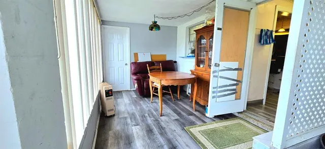 a dining room with furniture and wooden floor