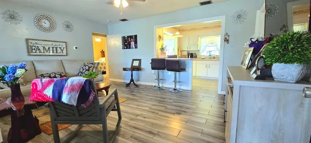 a living room with furniture and wooden floor