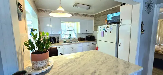 a kitchen with refrigerator and window