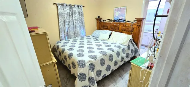 a bedroom with a bed and a curtain