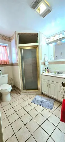 a bathroom with a sink a toilet and a shower