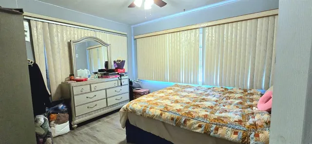 a bedroom with a bed dresser and a large mirror