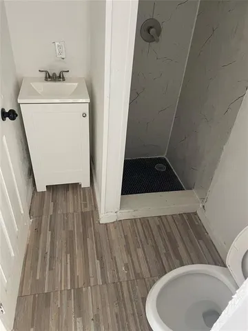 a room with wooden floor washer and dryer