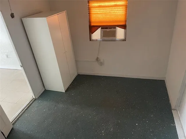 a view of a room with wooden floor and a window