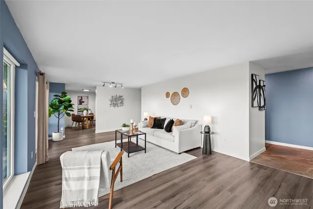 a living room with furniture and a wooden floor