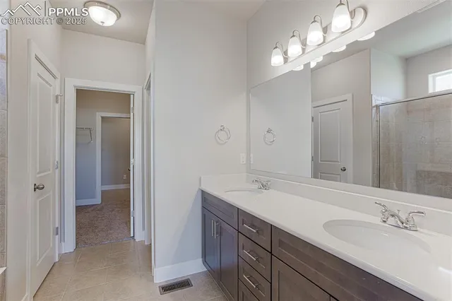 a bathroom with a double vanity sink and a mirror