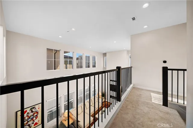 a view of a hallway with a white walls and stairs