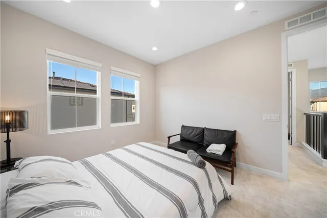 a bedroom with a large bed and a window