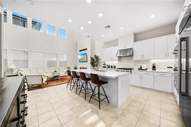 a kitchen with stainless steel appliances kitchen island granite countertop a sink and cabinets