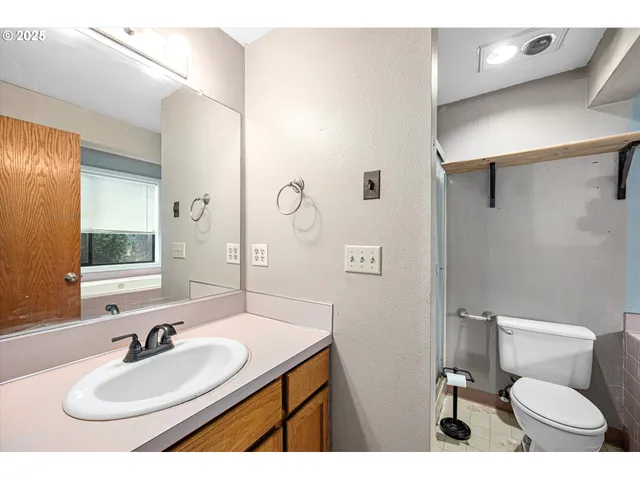 a bathroom with a sink toilet and mirror