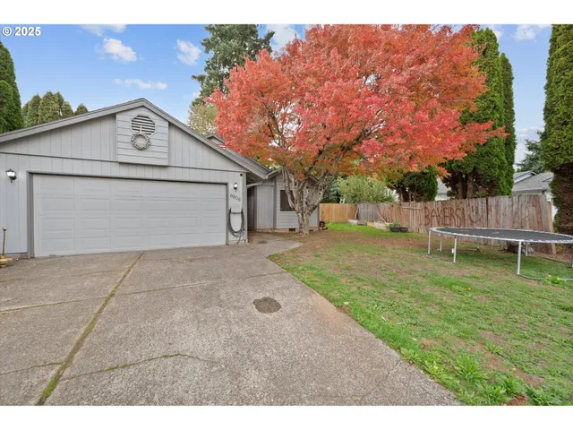 a view of a yard with wooden fence
