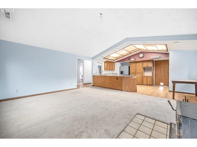 a view of a bedroom with a large bed and a window
