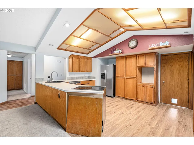 a kitchen with stainless steel appliances granite countertop a stove and a refrigerator