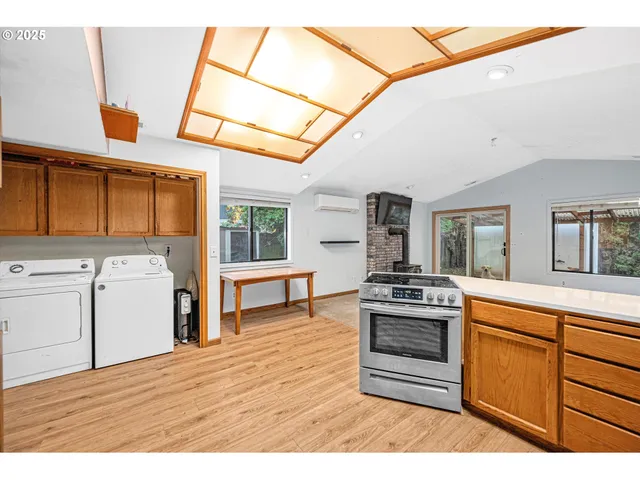 a kitchen with stove and cabinets