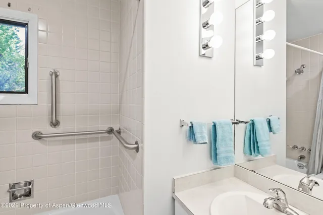 a bathroom with a sink and mirror