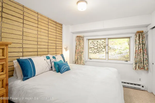 a bedroom with a large bed and a large window