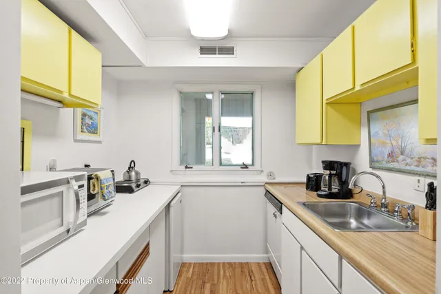 a kitchen with a sink and a stove top oven
