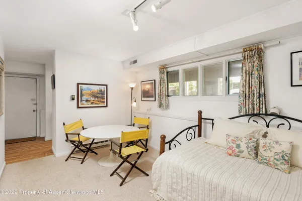 a bedroom with a bed a table and chair
