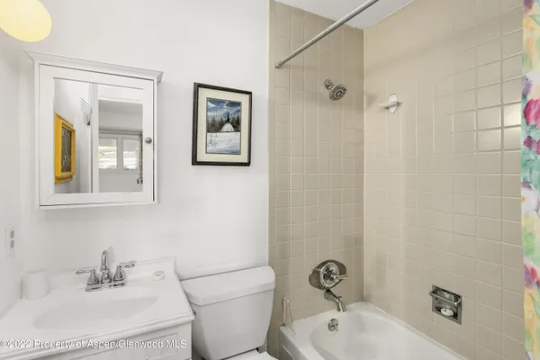 a bathroom with a sink mirror and toilet