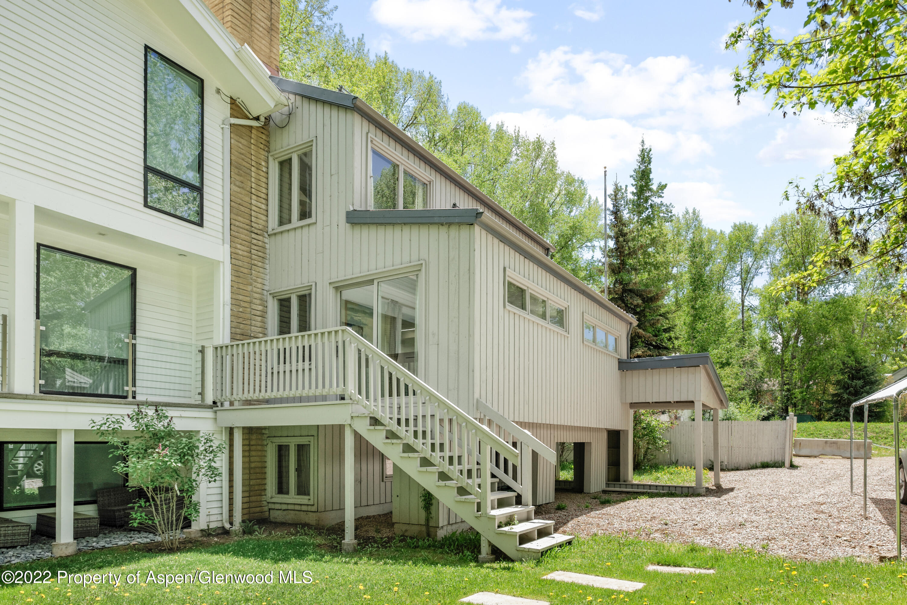 521 North 7th Street, Unit B Aspen, CO 81611 - Photo 20 of 26 a view of a white house with a big yard plants and large trees