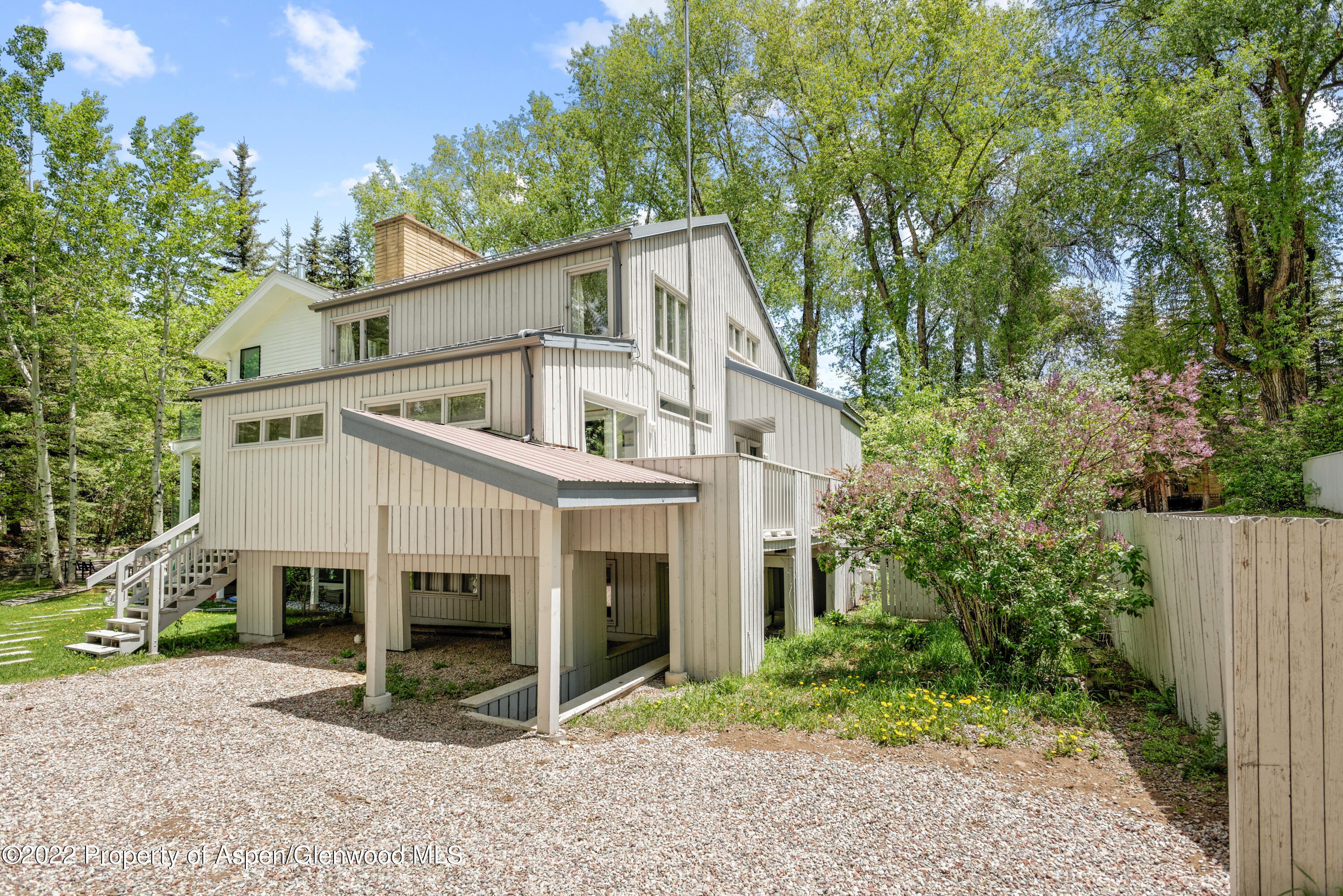521 North 7th Street, Unit B Aspen, CO 81611 - Photo 21 of 26 a white house that has a tree in front of it