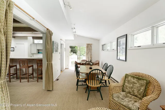 a dining room with furniture and window