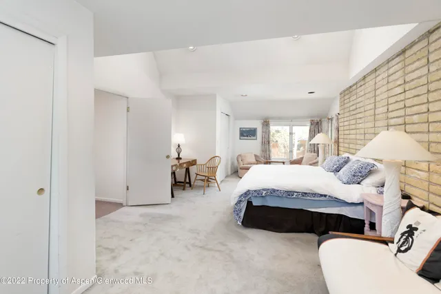 a spacious bedroom with a bed and window