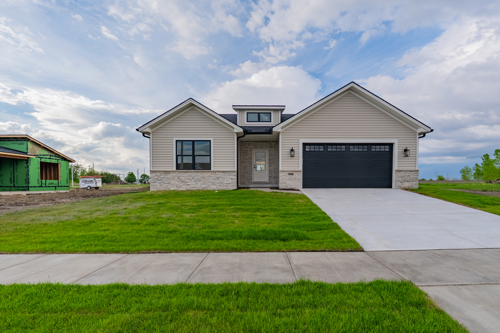 a front view of a house with a garden and yard