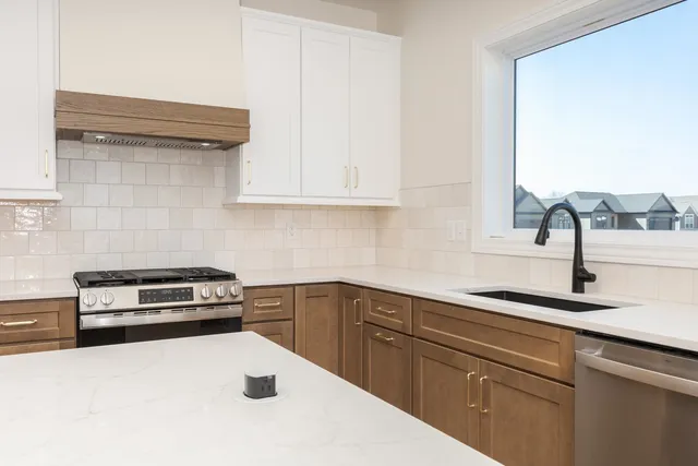 a kitchen with a sink cabinets and appliances
