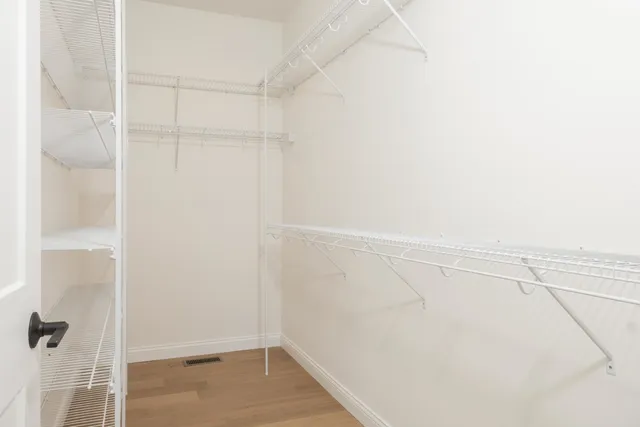 a bathroom with a double vanity sink and mirror with shower