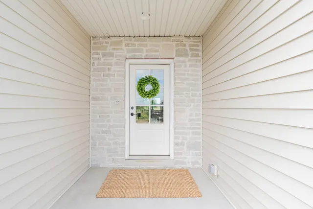 a view of a door and wooden floor