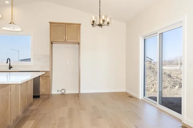 a view of a room with wooden floor and white walls