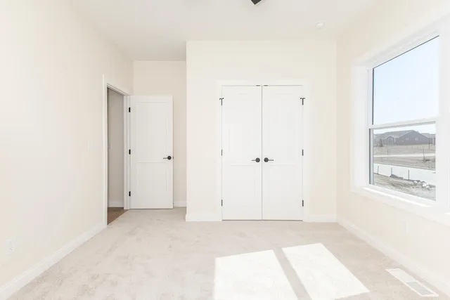 a bathroom with a granite countertop sink toilet and mirror