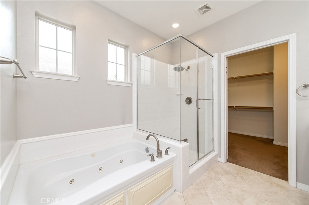77 Hallmark Irvine, CA 92620 - Photo 14 of 35 a bathroom with a tub a sink and a shower