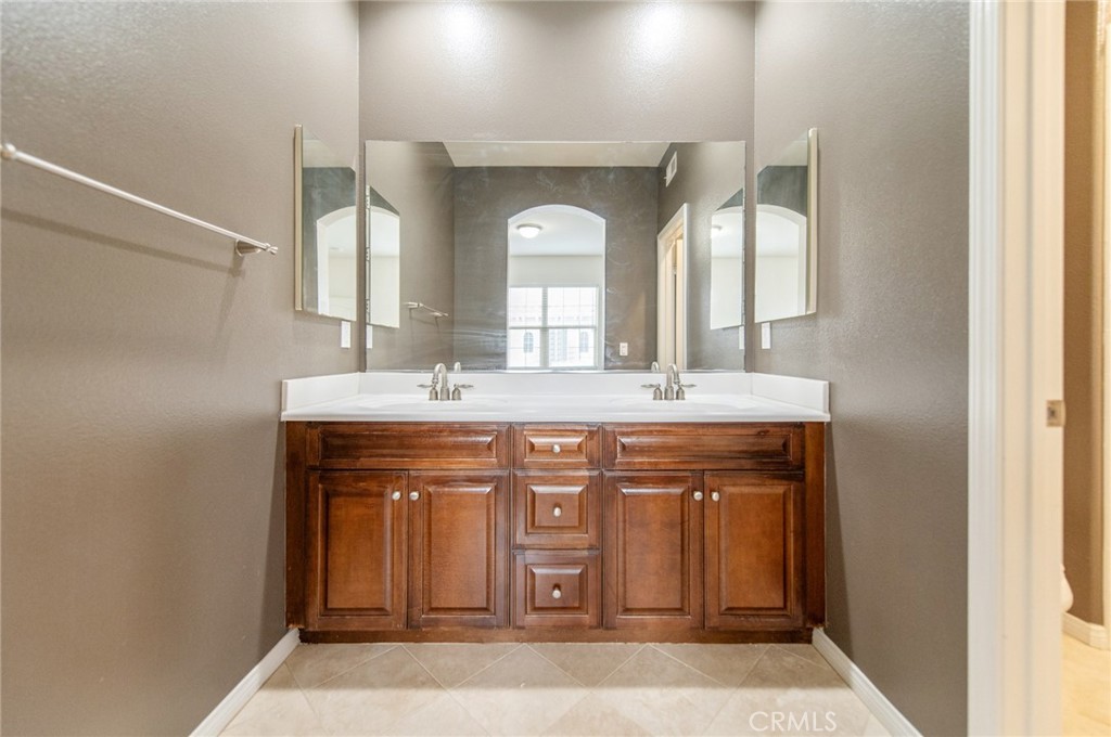 77 Hallmark Irvine, CA 92620 - Photo 16 of 35 a bathroom with a double vanity sink and a mirror