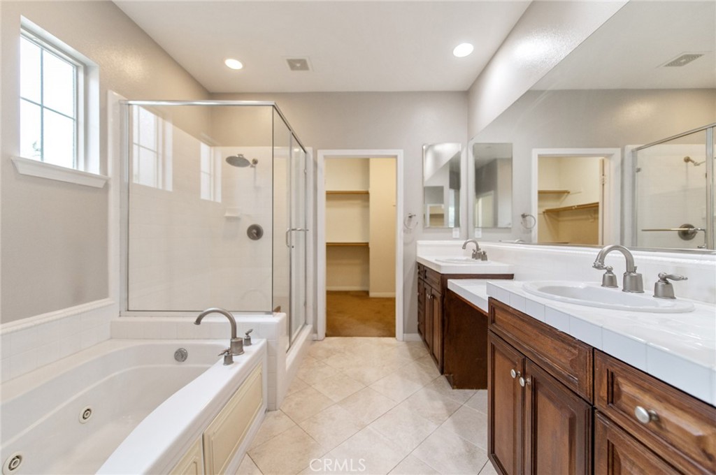 77 Hallmark Irvine, CA 92620 - Photo 17 of 35 a spacious bathroom with a bathtub shower sink double and mirror