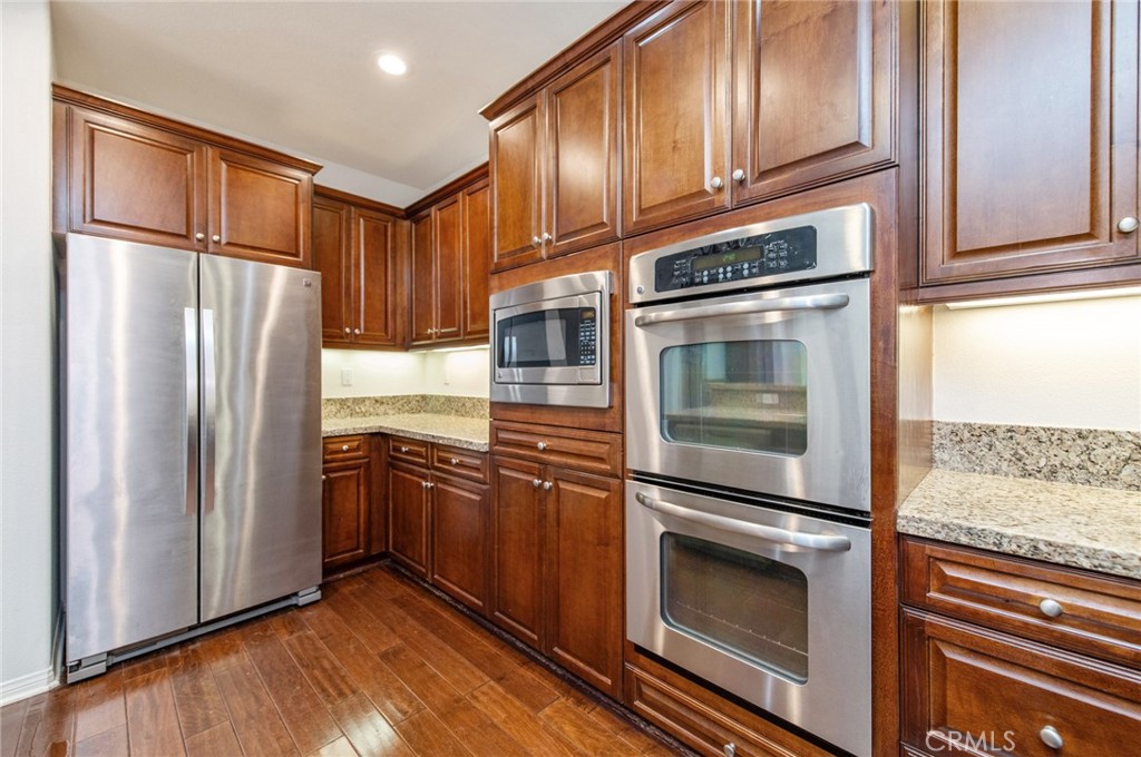 77 Hallmark Irvine, CA 92620 - Photo 21 of 35 a kitchen with granite countertop stainless steel appliances and wooden cabinets