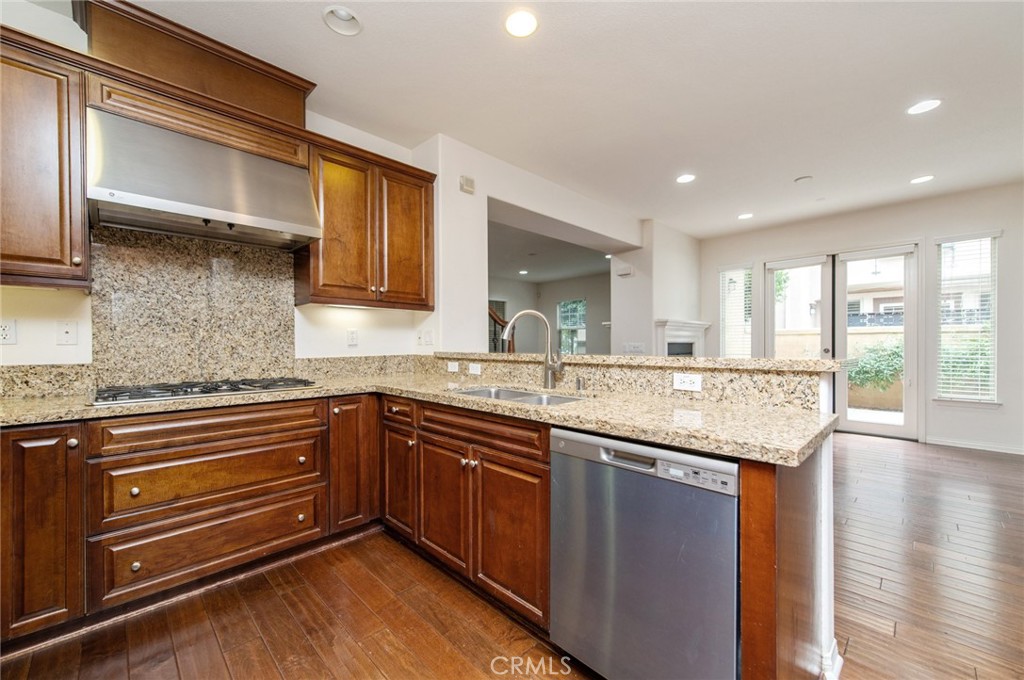 77 Hallmark Irvine, CA 92620 - Photo 22 of 35 a kitchen with granite countertop stainless steel appliances and wooden cabinets