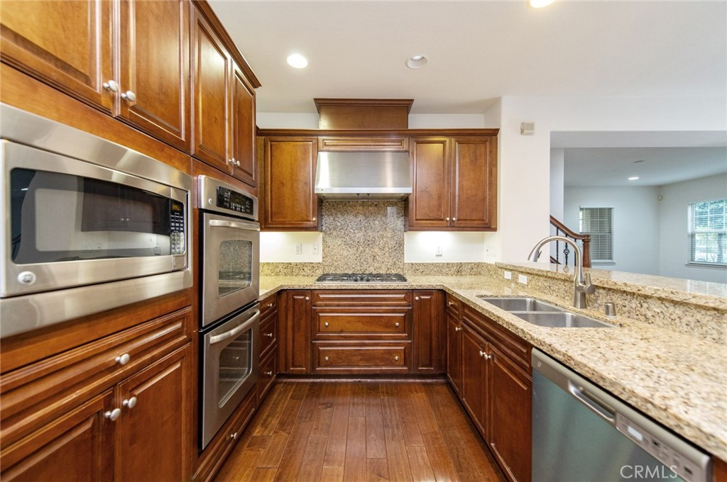 77 Hallmark Irvine, CA 92620 - Photo 23 of 35 a kitchen with granite countertop stainless steel appliances and wooden cabinets