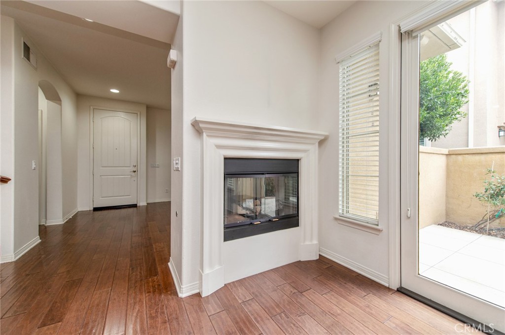 77 Hallmark Irvine, CA 92620 - Photo 6 of 35 a view of a hallway with wooden floor and a fireplace
