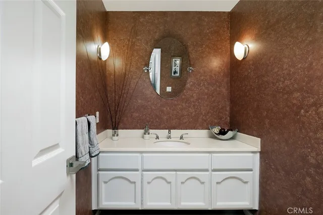 a bathroom with a sink vanity and a mirror
