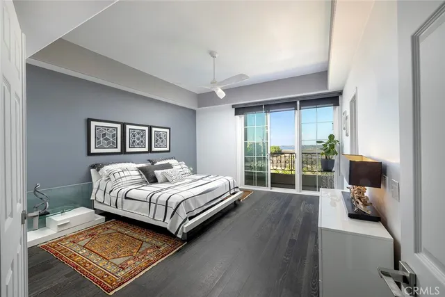 a bedroom with a bed and a flat tv screen on dresser