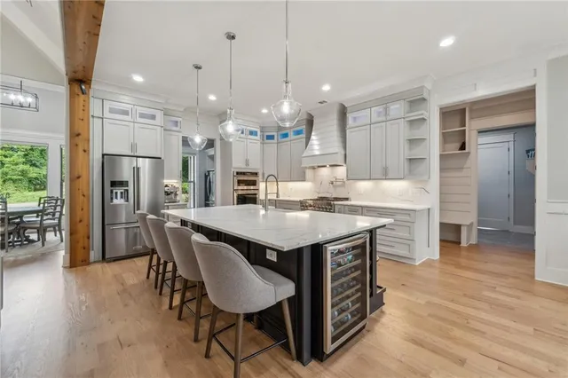 a large kitchen with stainless steel appliances lots of counter space and windows