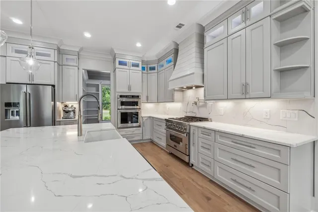a kitchen with stove and wooden floor