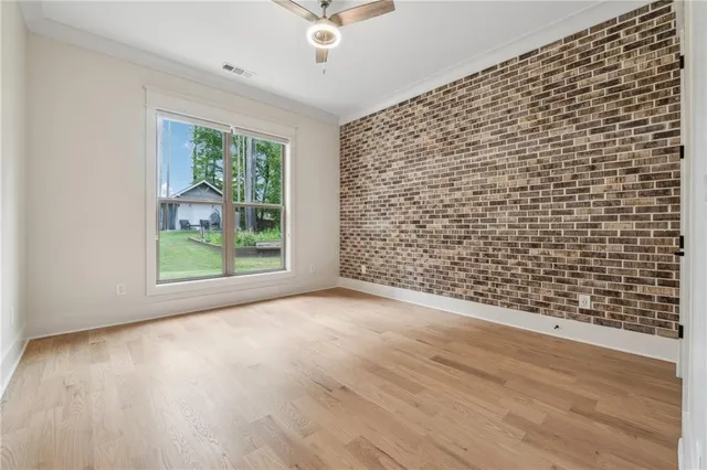 a bed sitting in a spacious bedroom next to a window