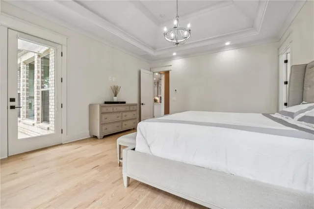 an empty room with wooden floor and a ceiling fan