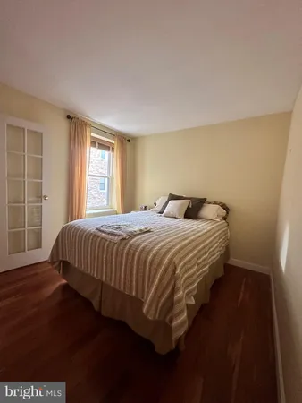 a bedroom with a bed and window