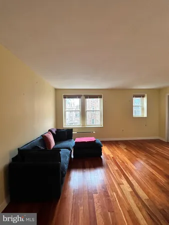 a living room with a bed furniture and a window
