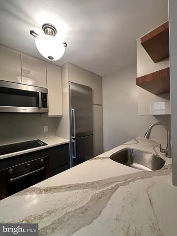 a kitchen with a sink and stainless steel appliances