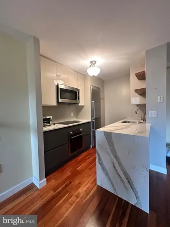 a kitchen with kitchen island and stainless steel appliances